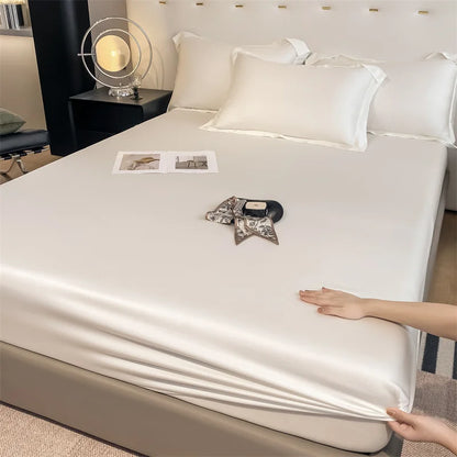 Person unrolling a satin sheet on a bed in a bedroom setting