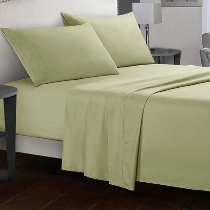 Green bed sheets and pillows on a bed in a bedroom setting.