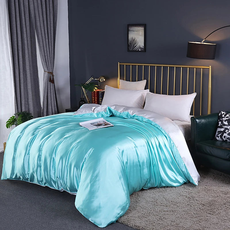 Turquoise comforter on a bed in a bedroom with dark walls and a gold headboard.