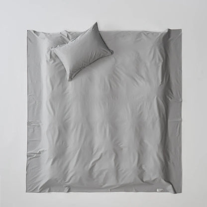 Light gray bedding set with a pillow on a white background