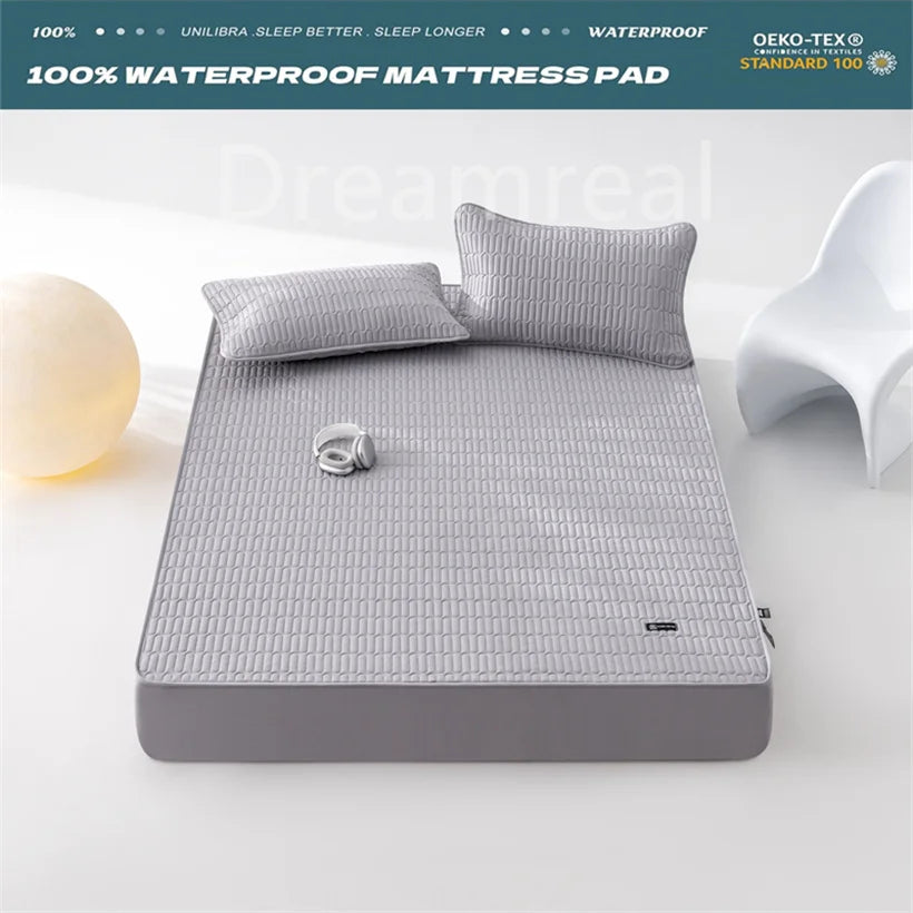 Gray waterproof mattress pad with pillows on a white bed, featuring certification logos at the top.