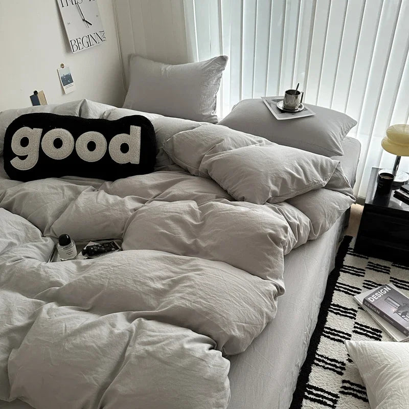 Neatly made bed with white bedding and pillows, featuring a 'good' pillow in a bedroom setting.