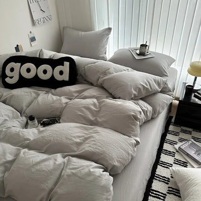 Neatly made bed with white bedding and pillows, featuring a 'good' pillow in a bedroom setting.