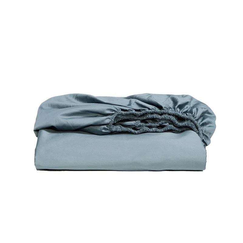 Folded light blue fitted sheet on a white background