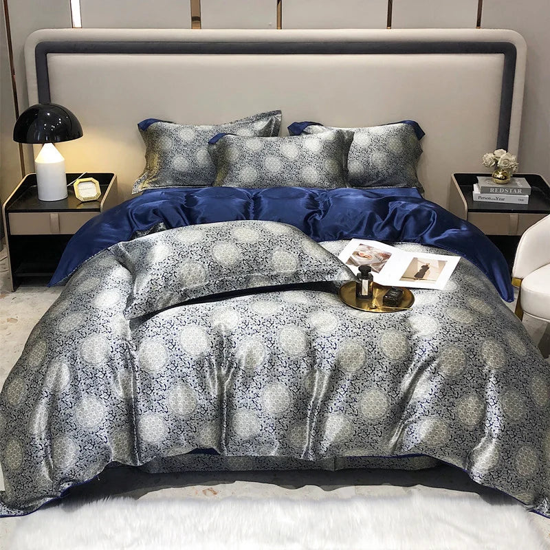 Bed with blue and gray patterned bedding in a bedroom setting.
