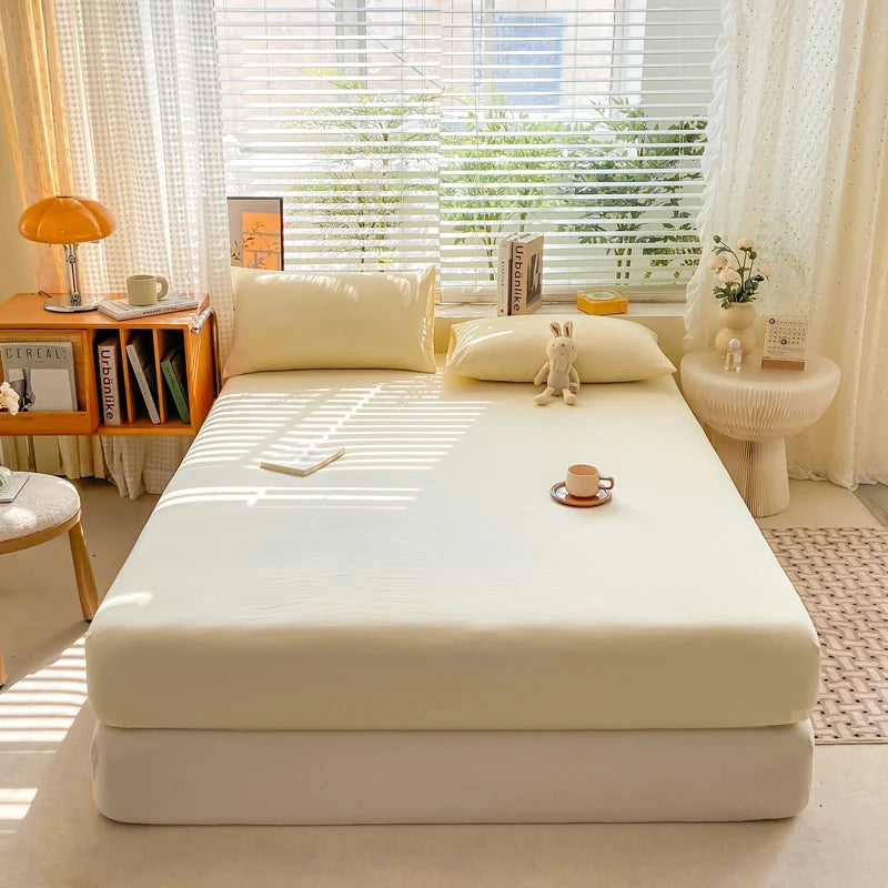 Bed with white mattress cover in a bright bedroom