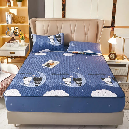 Blue quilt with cartoon designs on a bed in a bedroom setting