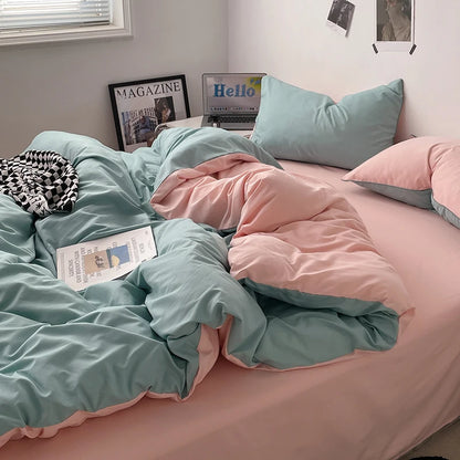 Bed with pink and green bedding, pillows, and a magazine.