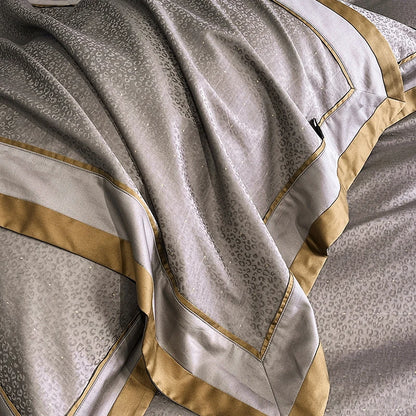 Close-up of a textured fabric with gold trim and patterns
