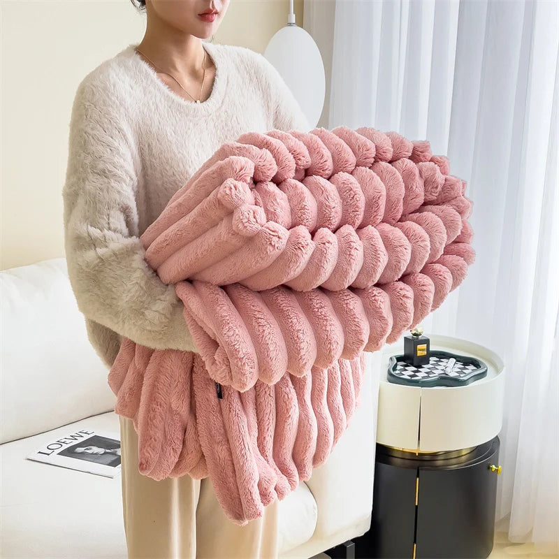 Person holding a pink textured blanket in a living room setting