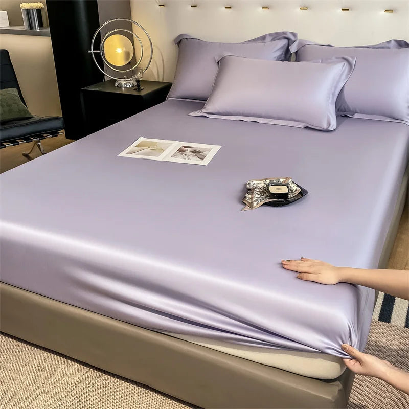 Purple satin sheet set on a bed with a person touching it, in a bedroom setting.