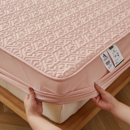 Person adjusting a pink mattress cover on a bed with a wooden frame.