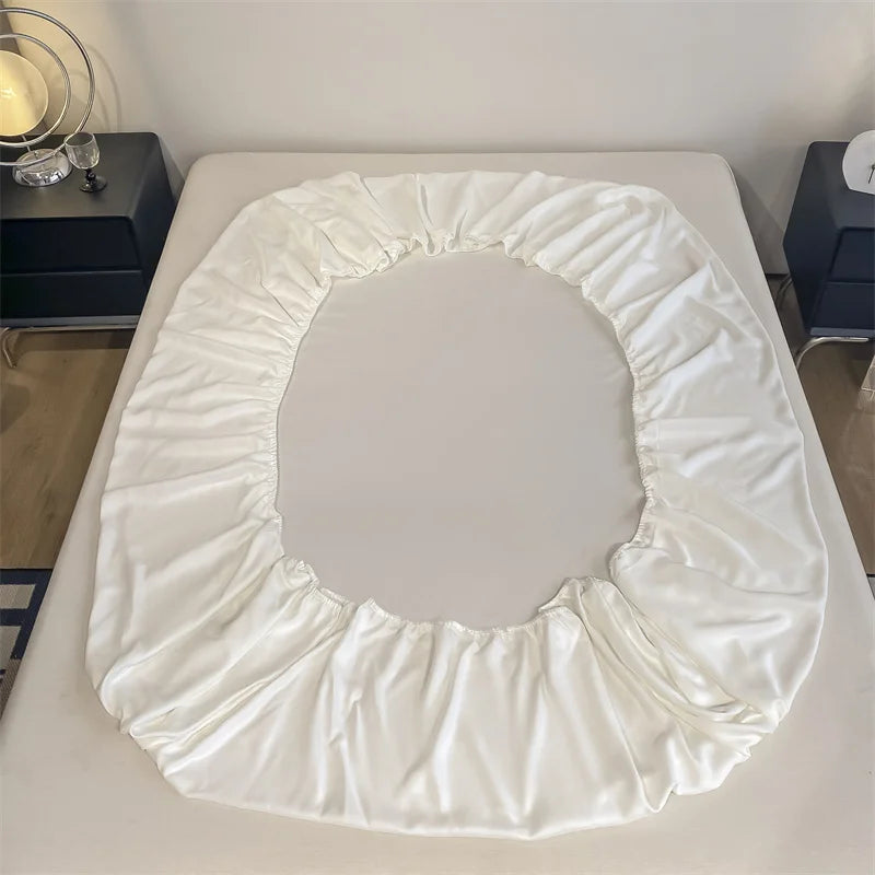 White fitted sheet on a bed in a bedroom setting