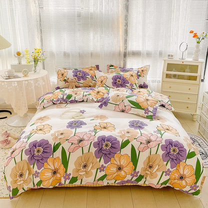 Floral bedding set on a bed in a bedroom with a dresser and table in the background.