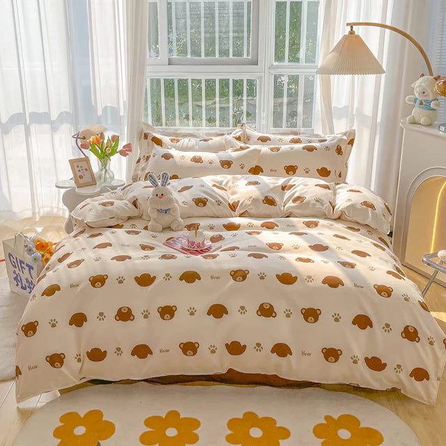 Bedroom with a bed featuring a teddy bear pattern, light streaming through a window.