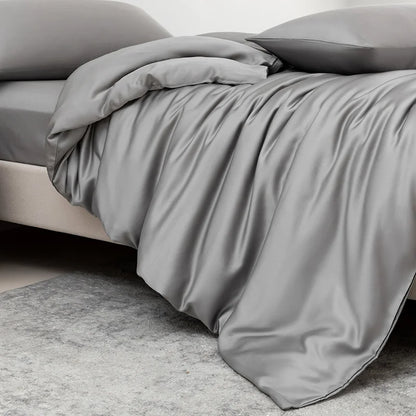 Gray bedding set on a bed with a neutral background