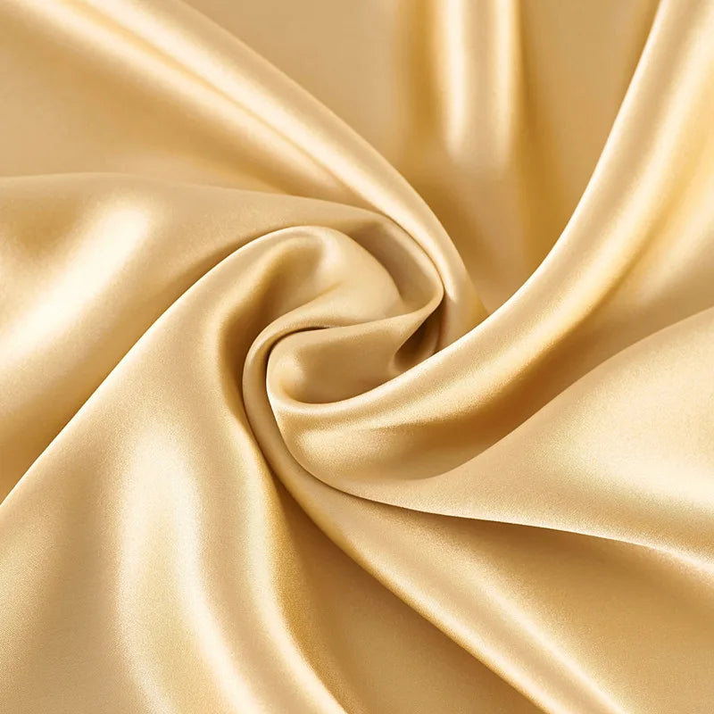 Close-up of beige satin fabric with folds