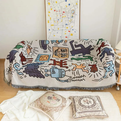 Decorative blanket with colorful abstract designs draped over a couch in a room with a map on the wall.