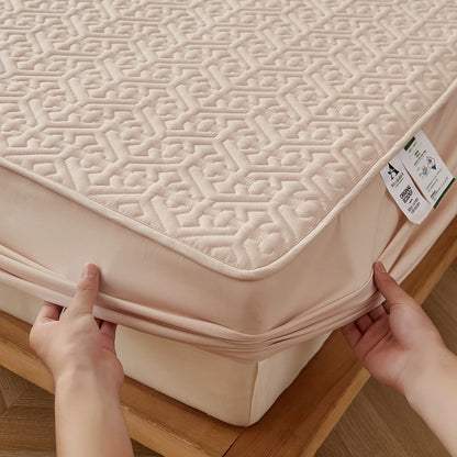 Person wrapping a beige mattress cover around a bed frame.