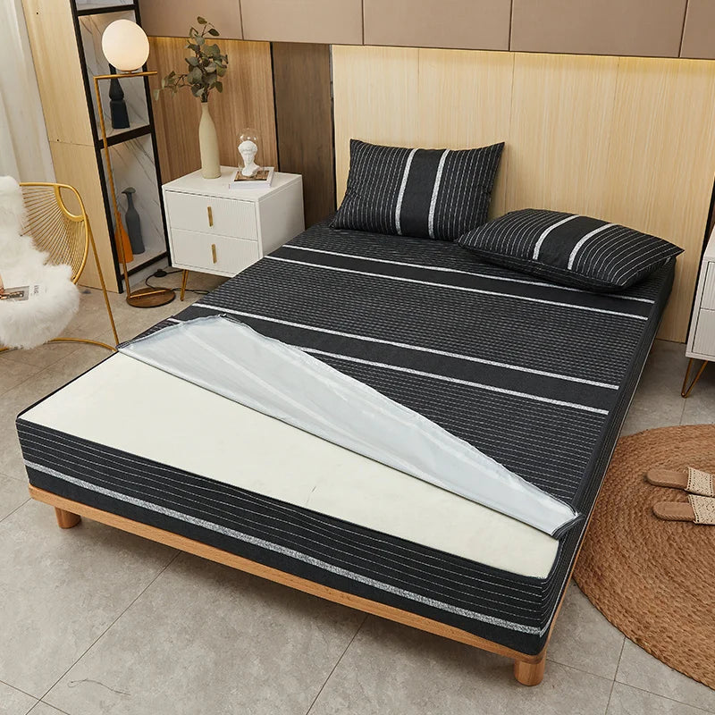 Bed with striped mattress cover and pillows in a bedroom setting