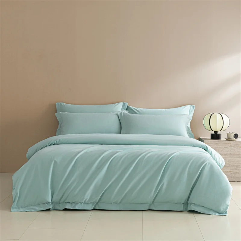 Teal bedding set on a bed against a beige wall.