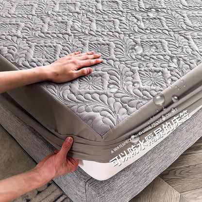 Person holding a gray mattress with textured surface on a wooden floor.
