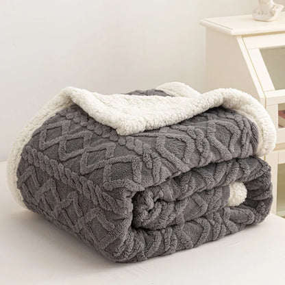 Gray textured blanket with white trim on a white surface