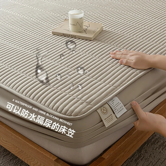 Beige waterproof bedsheet with a hand touching it, showing its texture and design.