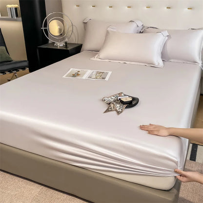 Person adjusting a fitted sheet on a bed in a bedroom setting.