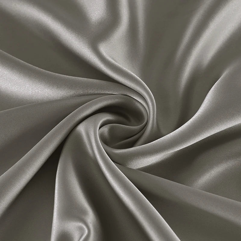 Close-up of gray satin fabric with folds
