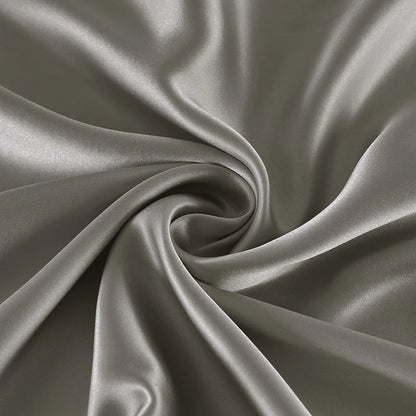 Close-up of gray satin fabric with folds