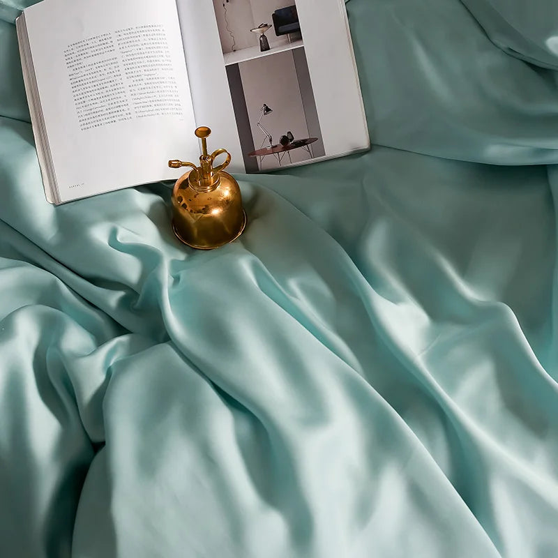 Light blue fabric with a gold decorative object and open book on top