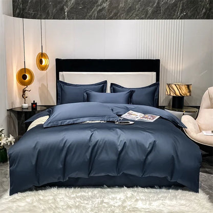 Blue bedding set on a bed in a modern bedroom with marble wall and decorative lamps.
