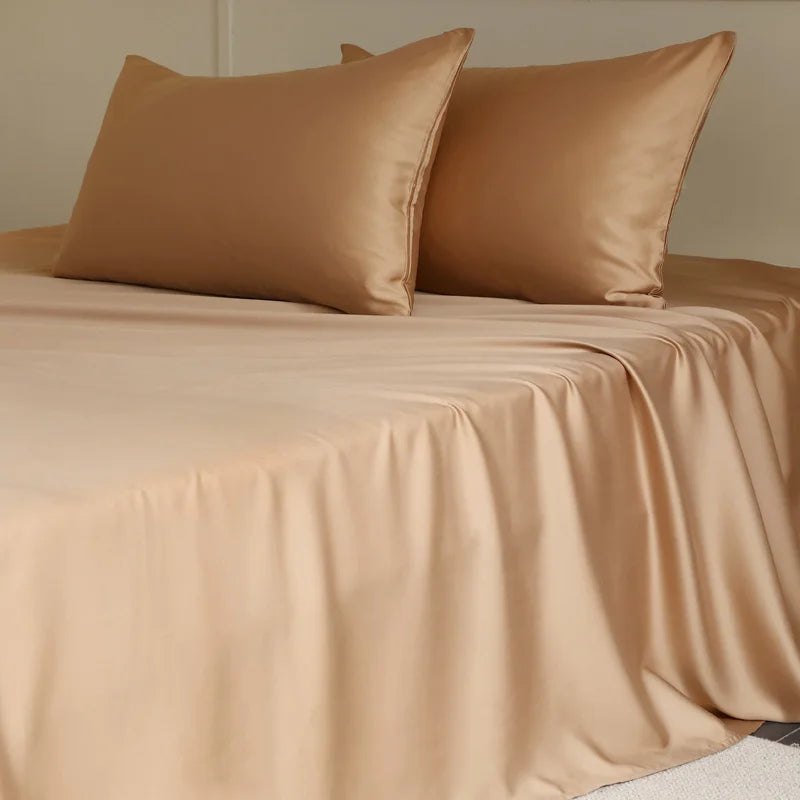 Beige bed sheets and pillows on a bed with a neutral background