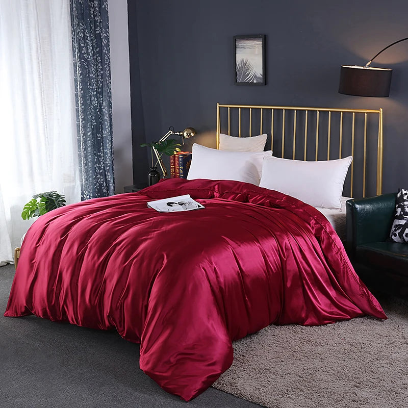 Bedroom with a bed featuring red bedding and gold headboard.