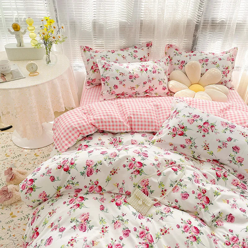 Floral and checkered bedding set on a bed with a side table and decorative items.