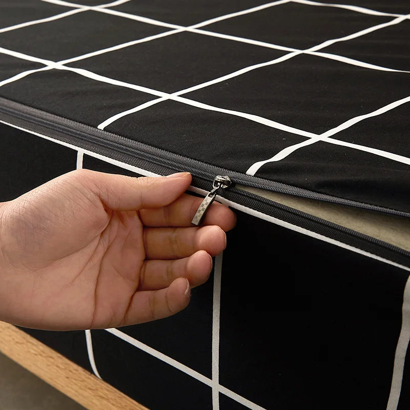 Hand zipping a black mattress cover with white grid pattern