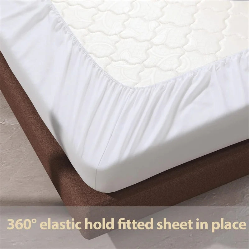 White fitted sheet on a bed with text '360° elastic hold fitted sheet in place'.