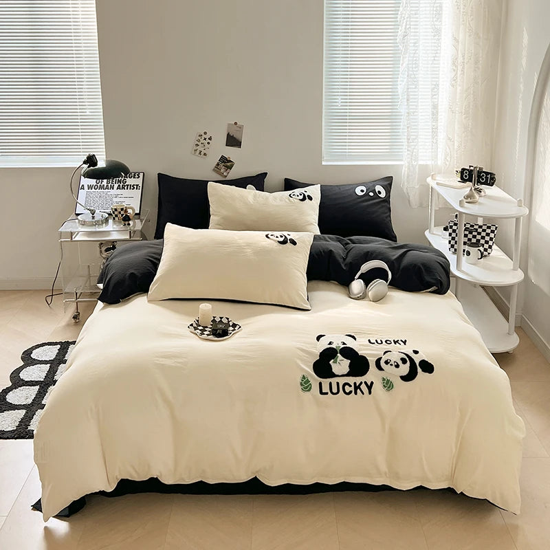 Beige bedspread with panda design on a bed in a room with windows and a desk.