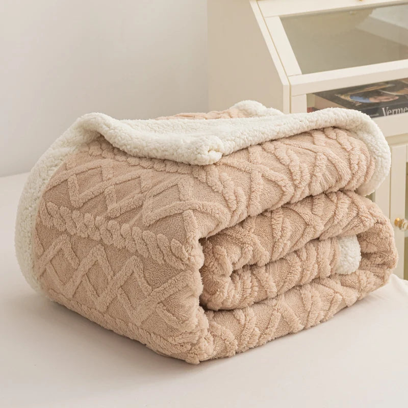 Folded beige textured blanket on a white surface