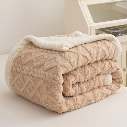 Folded beige textured blanket on a white surface