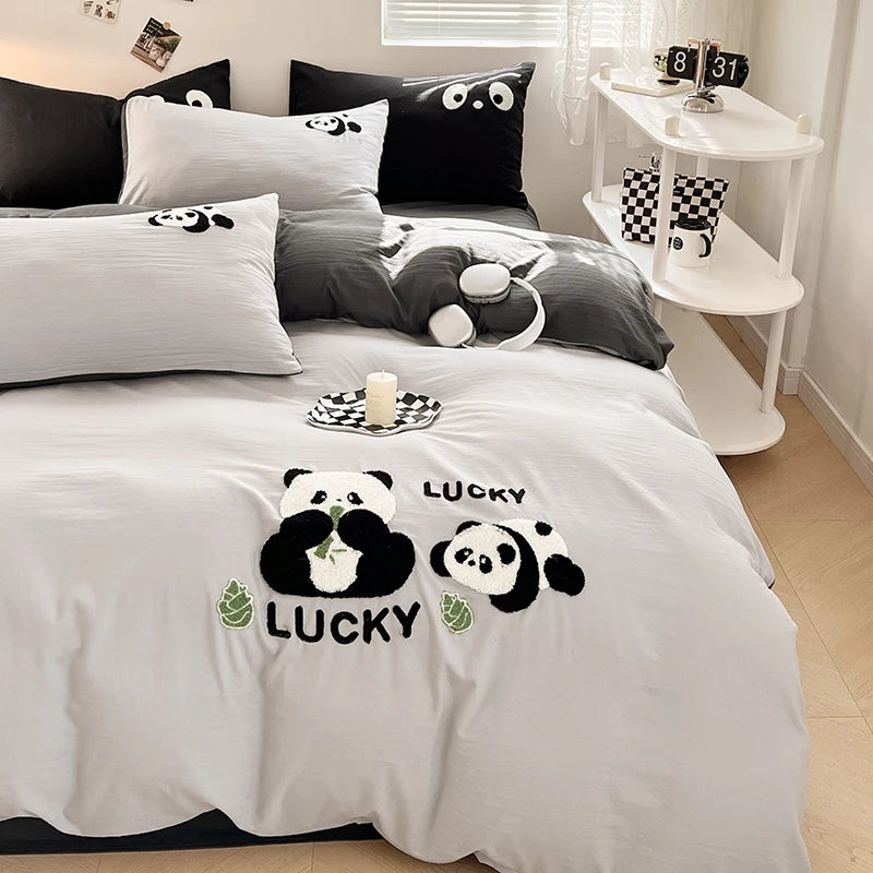 Bedding set with panda design and 'Lucky' text in a bedroom setting.