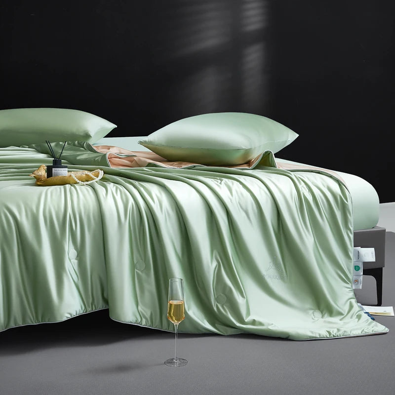 Green bedspread on a bed with a glass of wine on a dark background