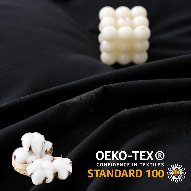 Cotton bolls and a cube on black fabric with OEKO-TEX Standard 100 logo.