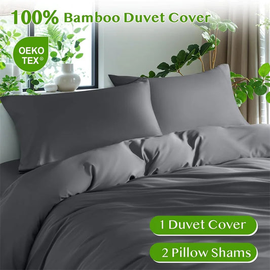 Gray bamboo duvet cover set with OEKO-TEX certification on a bed with plants in the background.