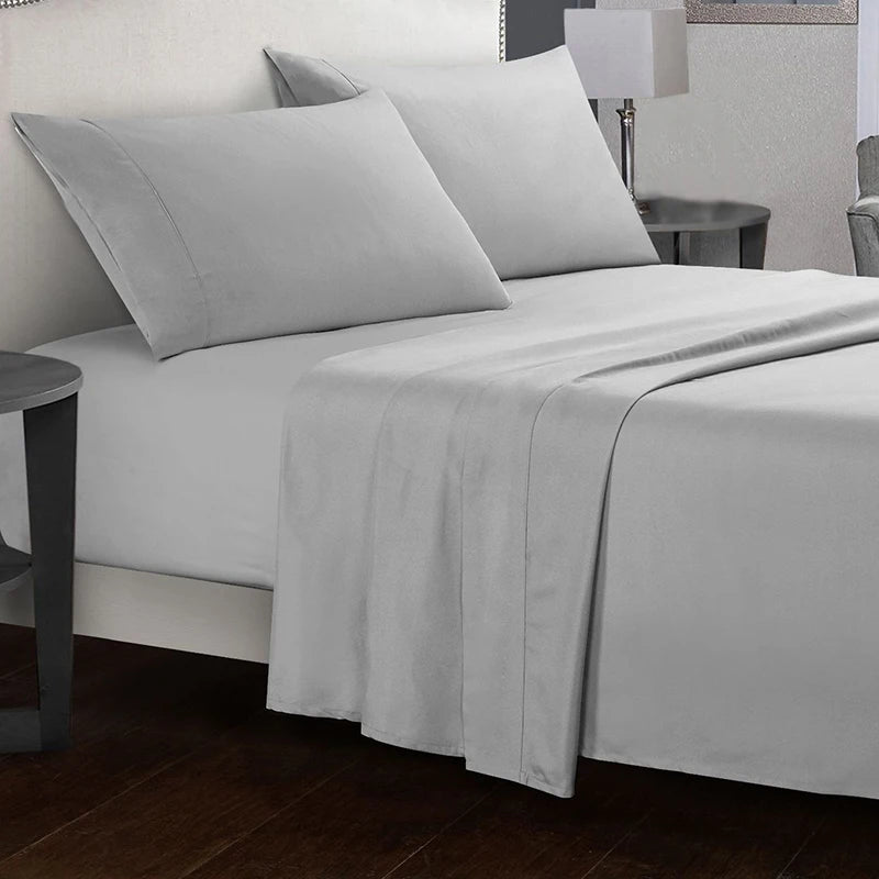 Gray bedding set on a bed in a bedroom setting