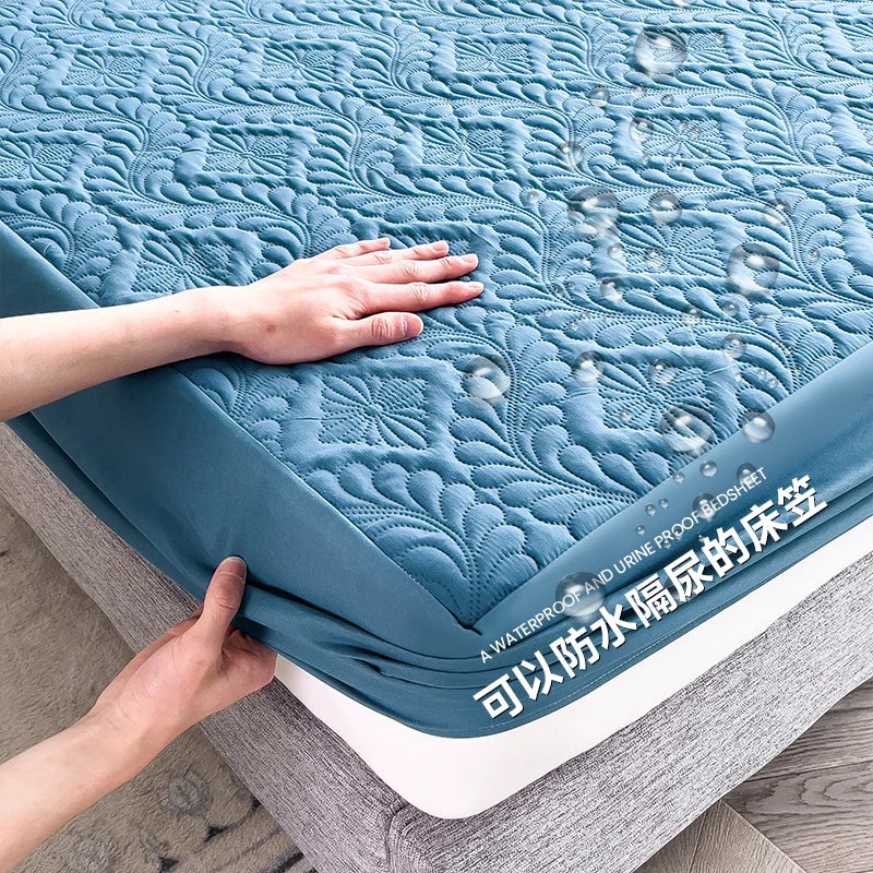 Blue mattress cover being stretched over a bed with water droplets on it.