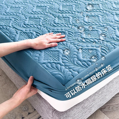 Blue mattress cover being stretched over a bed with water droplets on it.
