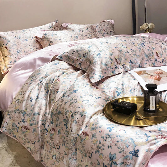 Floral patterned bedding set on a bed with a side table featuring a lamp and books.
