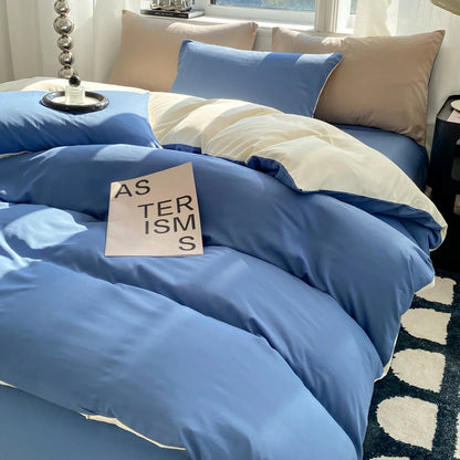 Blue bedding set with a sign on a bed in a room with a window.